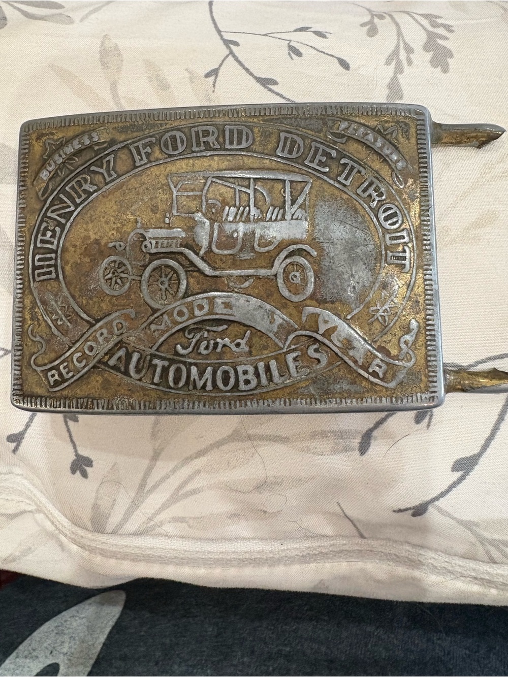 Vintage Ford Model T belt buckle shows wear